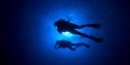 Scuba divers in deep blue water